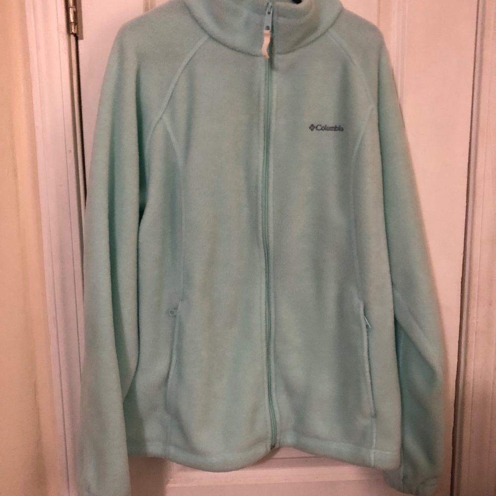 Fleece jacket  has stand up collar. Elastic in sleeve. Zip pockets